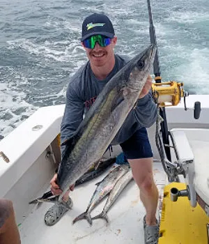 Nice mackerel being held by happy angler.