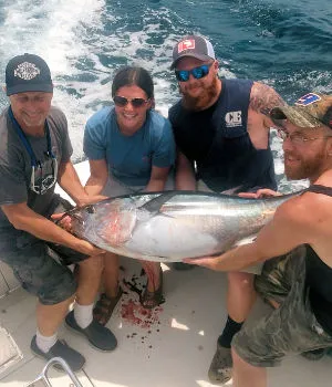 An Ocean City charter group holding up very large tuna.